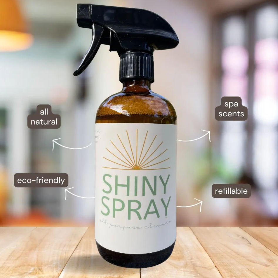 Shiny Spray bottle with label on a wooden surface